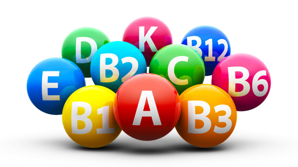 Imagem com bolas coloridas com a letra de vitaminas dentro.